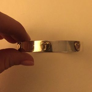 Tiffany & Co silver bangle with gold key holes.